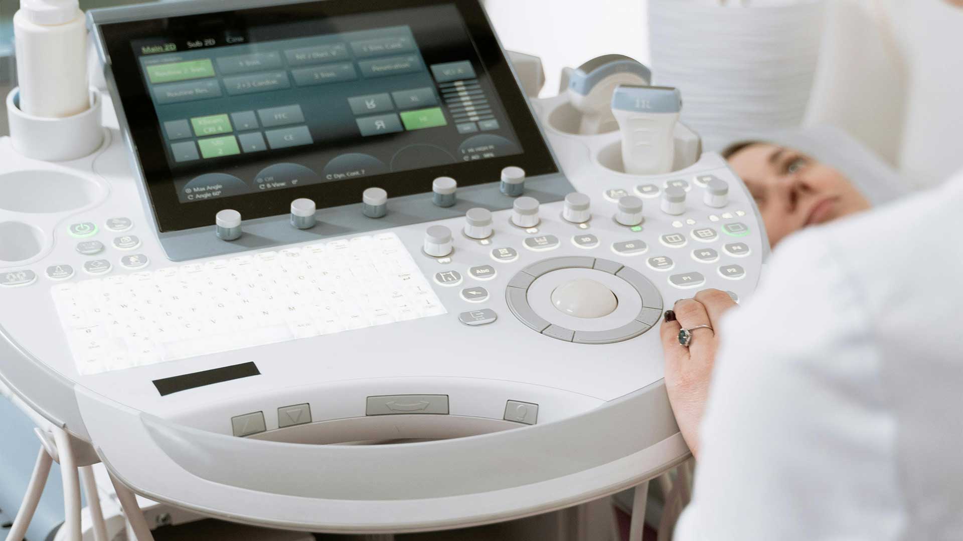 Sonographer performing a 3D/4D ultrasound scan during a hands-on training session